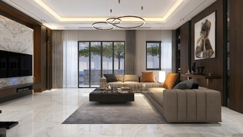 Bố trí nội thất phòng khách cao cấp ấn tượng với cách trang trí cuốn hút đối lập giữa hai mảng tường chính: bức tranh canvas trừu tượng nâu trầm trừu tượng tương phản với sự mạnh mẽ từ khối đá đối vân lớn. Tổng hợp các mẫu thiết kế đá ốp tường phòng khách cao cấp